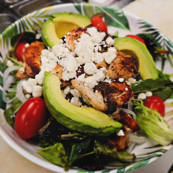 Mima's Cuban Cafe's salad with grilled chicken, avocado, cherry tomatoes, and feta cheese.